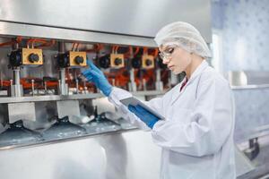 Women worker work in drink water factory inspect check quality drinking water filling machine control operate photo