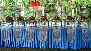 a table with several large silver bowls on it photo