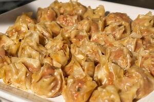 a plate of dumplings sitting on a table photo
