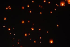 Lanterns floating in the night sky during Vesak Day ceremony in Borobudur Temple, Magelang. photo