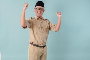 Excited Indonesian government worker man posing with a happy successful expression. photo