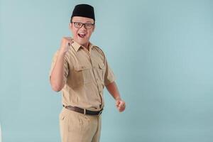 Excited Indonesian government worker man posing with a happy successful expression. photo