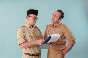 Two thoughtful government worker men holding document report with serious expression. photo