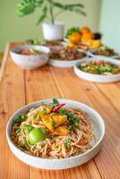 The Khao Soi Yuan Naan that is served on the plate is Khao Soi noodles mixed with minced pork spring onion coriander and chili lime and sesame spicy and sour. noodles chinese food tai yai food photo