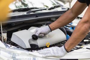 car service center mechanics are checking condition car and engine make sure they are ready use and in perfect condition according center warranty. periodic vehicle inspections for safety in driving. photo