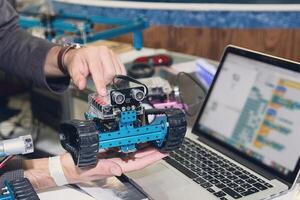 Model of a robot in the hands of a teacher during a robotics lesson photo