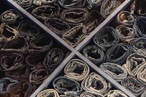 A stack of various folded jeans in a clothing store window photo