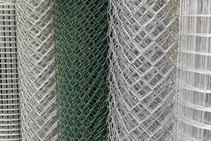 Rolled chain-link fence. Metal mesh netting rolled into rolls photo