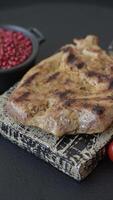 Grilled beef or pork steak with salt, spices and herbs on a dark concrete background video