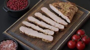Grilled beef or pork steak with salt, spices and herbs on a dark concrete background video
