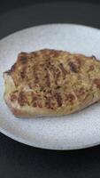 Grilled beef or pork steak with salt, spices and herbs on a dark concrete background video