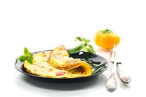 fried omelette with sweet pepper and vegetables in a plate, isolated on white background . photo