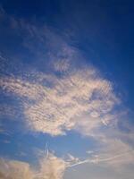 Vibrant cloudscape, where clouds in a fluffy formations, Sunshine reflects off the fluffy formations photo