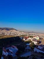 A view of the city from a distance and from the top during the charming evening hours before sunset photo