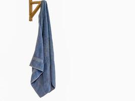 blue towel on a towel hook a against on white background photo