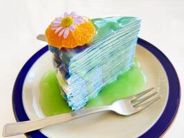 Colorful layer cake on white background photo