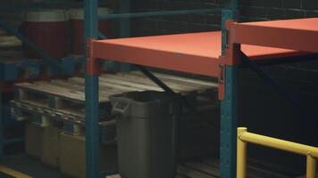 Red Bench Beside Trash Can in Empty Warehouse video