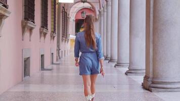 Lady with ponytail walks on marble floor of building gallery video