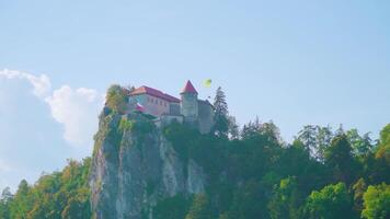 Old Bled castle with red rooftops standing on top of cliff video