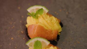 Couple of cakes with custard lime and mint lie on grey table video