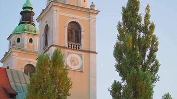 Closeup view of building with monograms and clock on wall video