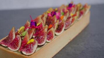 Biscuit decorated with fig slices standing on grey surface video
