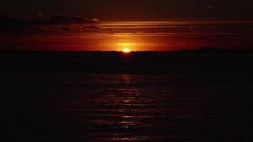 Setting sun reflects on lagoon creating sunlight path video