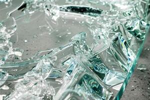 Broken tempered glass sheet presenting different shapes and textures photo