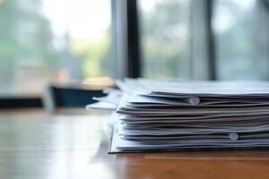 Stack of paperwork sitting on desk in office setting photo