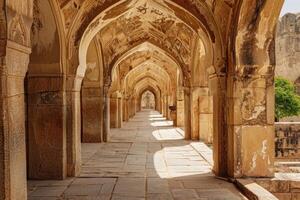 Stone archway creating light and shadows in ancient indian mosque photo