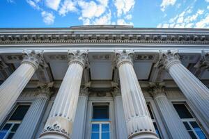 Majestic building facade with corinthian columns reaching for a blue sky photo