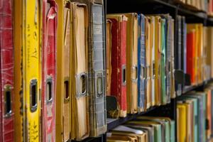 Old dusty files sitting on shelf in archive room photo