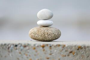 Stack of white and grey balancing stones on top of each other photo