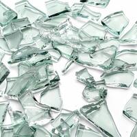 Pile of sharp transparent shards of broken glass lying on white background photo