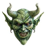 Green demon mask grinning showing sharp teeth photo