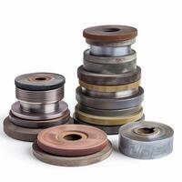 Different sizes and materials abrasive wheels for grinding machine are standing on white background photo