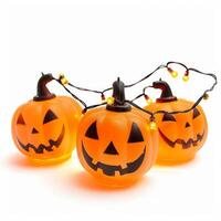 Three illuminated halloween pumpkins forming a string of lights on white background photo
