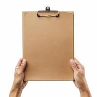 Hands holding empty clipboard with brown paper on white background photo