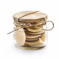 Glass jar filled with white chocolate confectionery covered with brown paper and tied with string photo
