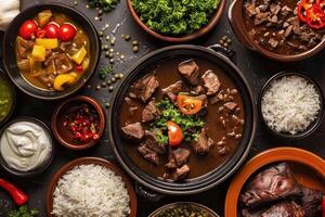 Feijoada, a traditional brazilian stew, served with rice, farofa, and various side dishes, creating a vibrant culinary scene photo