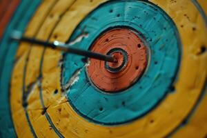 Arrow hitting the center of an archery target photo