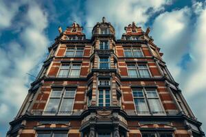 Imposing brick facade reaching for a cloudy sky in a low angle view photo