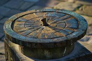 Weathered sundial casting a shadow on its stone base photo