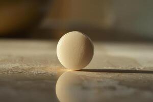 Round white pill casting a shadow on a tabletop photo