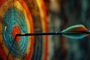 Arrow hitting the center of colorful archery target photo