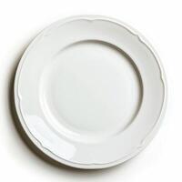 Empty white porcelain plate with scalloped edge on white background photo
