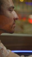 A powerful and intense expression displayed by a man in a dimly lit setting or environment video