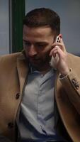 A Professional Individual Engaged in Using a Smartphone Within a Modern Office Setting video