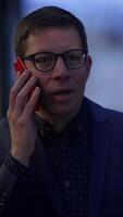 A professional man engaged in a conversation on his phone while dressed in business attire video