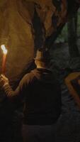 A Man with a Torch in a Dark Cave, Exploring the Mysteries of the Ancient Underground video